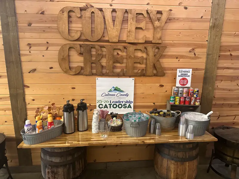 Rustic timber bar set with drinks and garnishes at a Covey Creek event