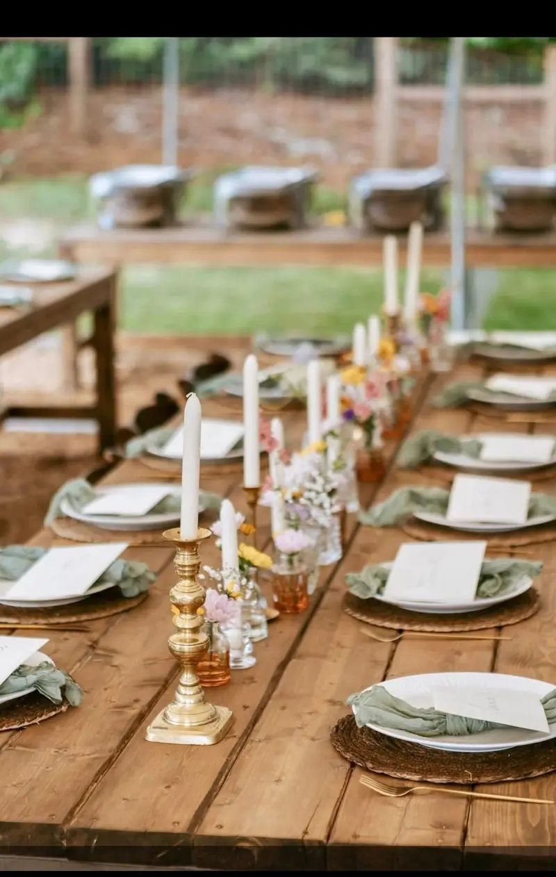 Place settings with gold candlesticks and soft spring florals